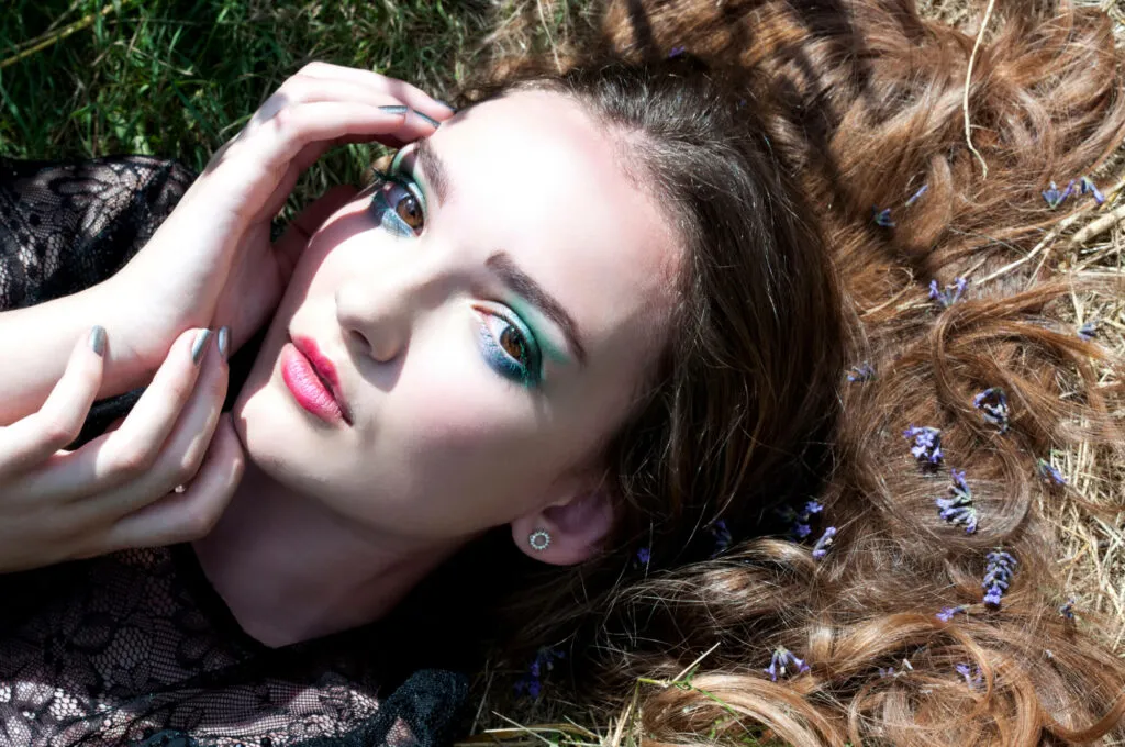 Commercial model looking at camera with eye shadow makeup by Bristol makeup artist Evie Smith