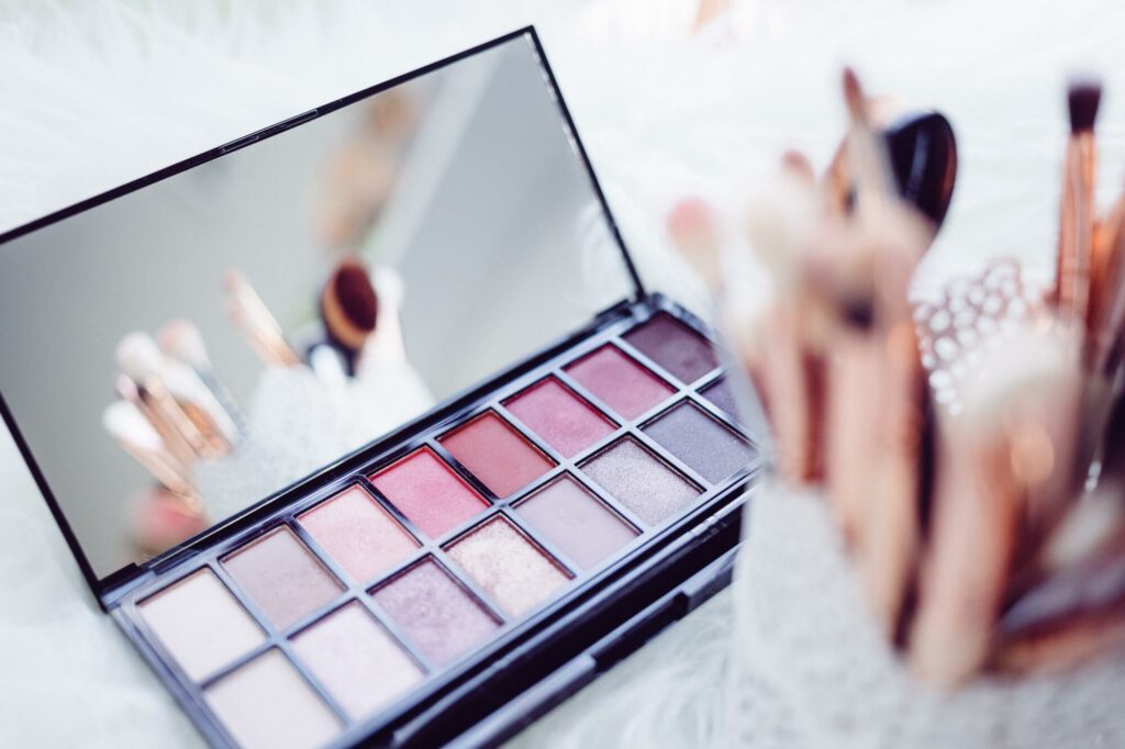 Stock photo of makeup and makeup brushes laid out artistically.