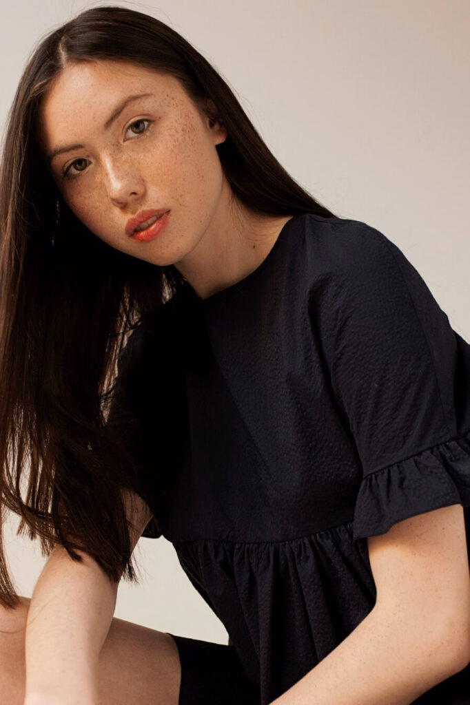 Commercial model posing for the camera with makeup by Bristol makeup artist Evie Smith