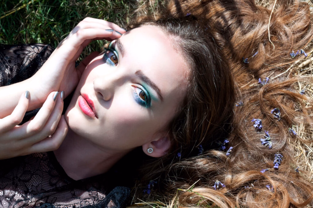 Commercial model looking at camera with eye shadow makeup by Bristol makeup artist Evie Smith