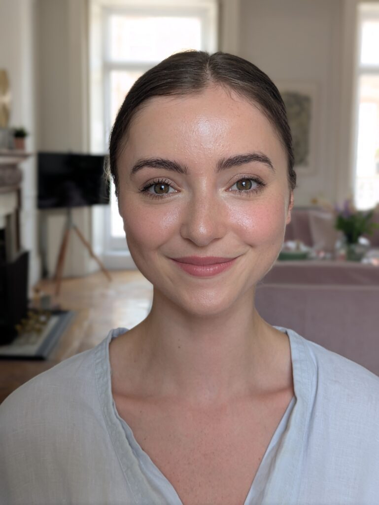 a bride looking into the camera. her makeup is fresh and natural. she is smiling. wedding in london.